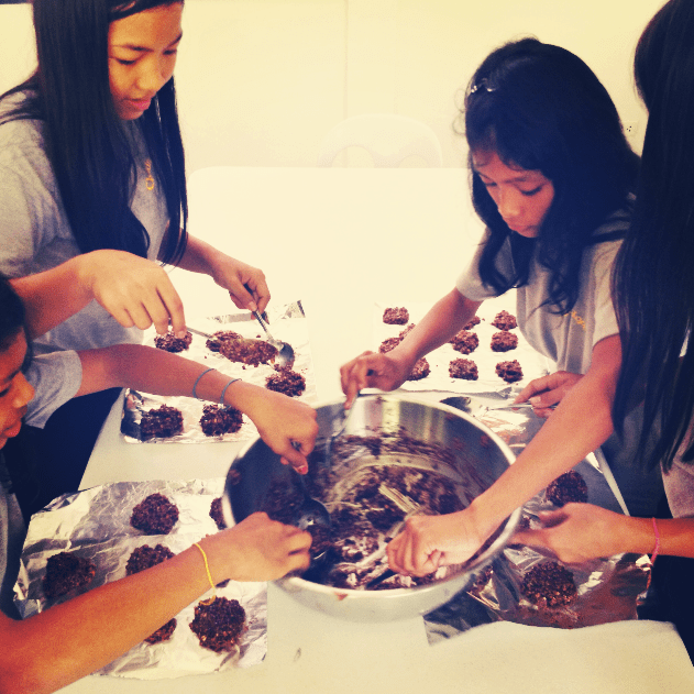 Young girls making Snickers cookies.