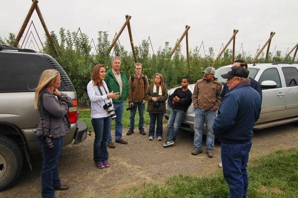 People at an apple orchard.