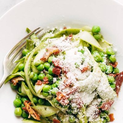 Pesto Asparagus Noodles in bowl with forks.