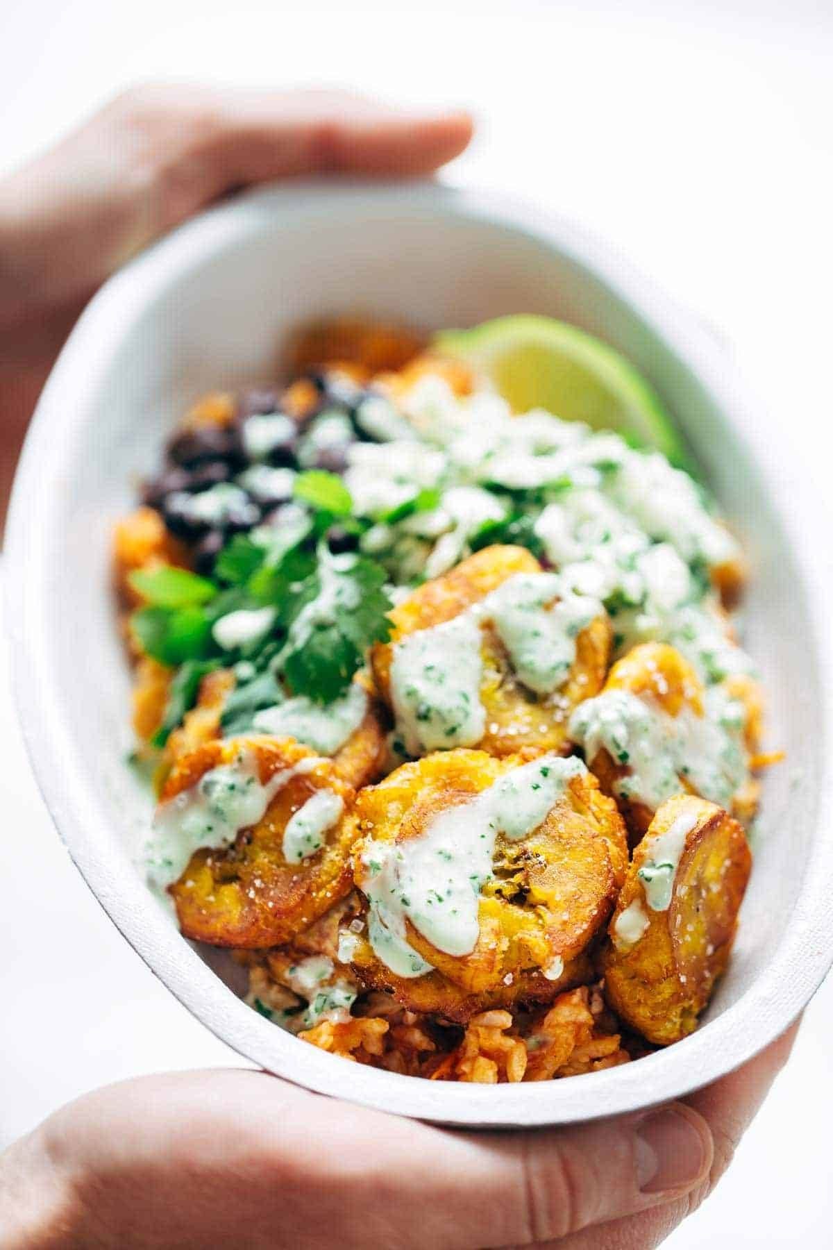 Spicy Brazilian Burrito Bowls recipe featuring seasoned rice and beans, garlic cilantro lime slaw, and crispy fried plantains. So good // almost vegan. | pinchofyum.com