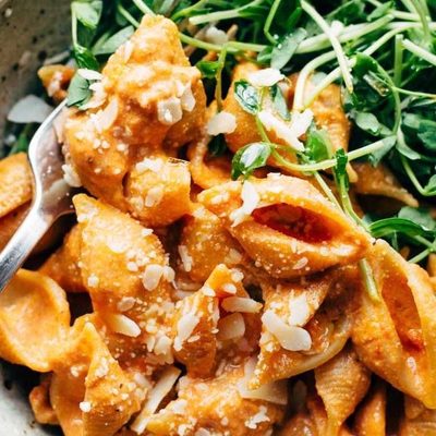 Creamy Tomato Shells in bowl with greens.