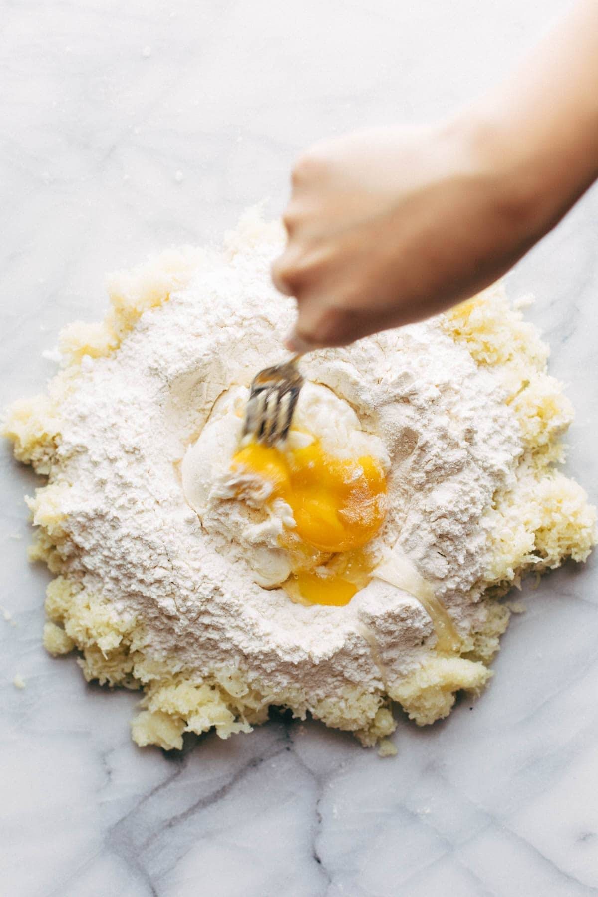 Adding egg to gnocchi.