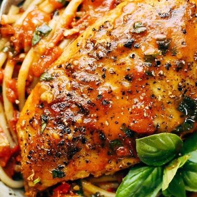 Garlic Basil Chicken in a bowl with spaghetti.