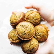 Lemon Zucchini Muffins held by hands.