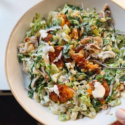 Smashed potato salad in a bowl.