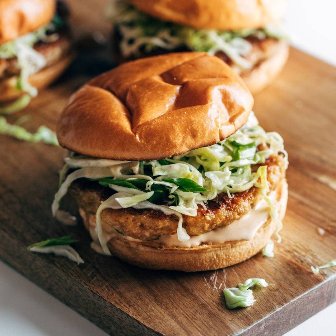 Chicken teriyaki burger on a board.