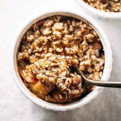 Single Serving Apple Crisp in a ramekin with spoon.