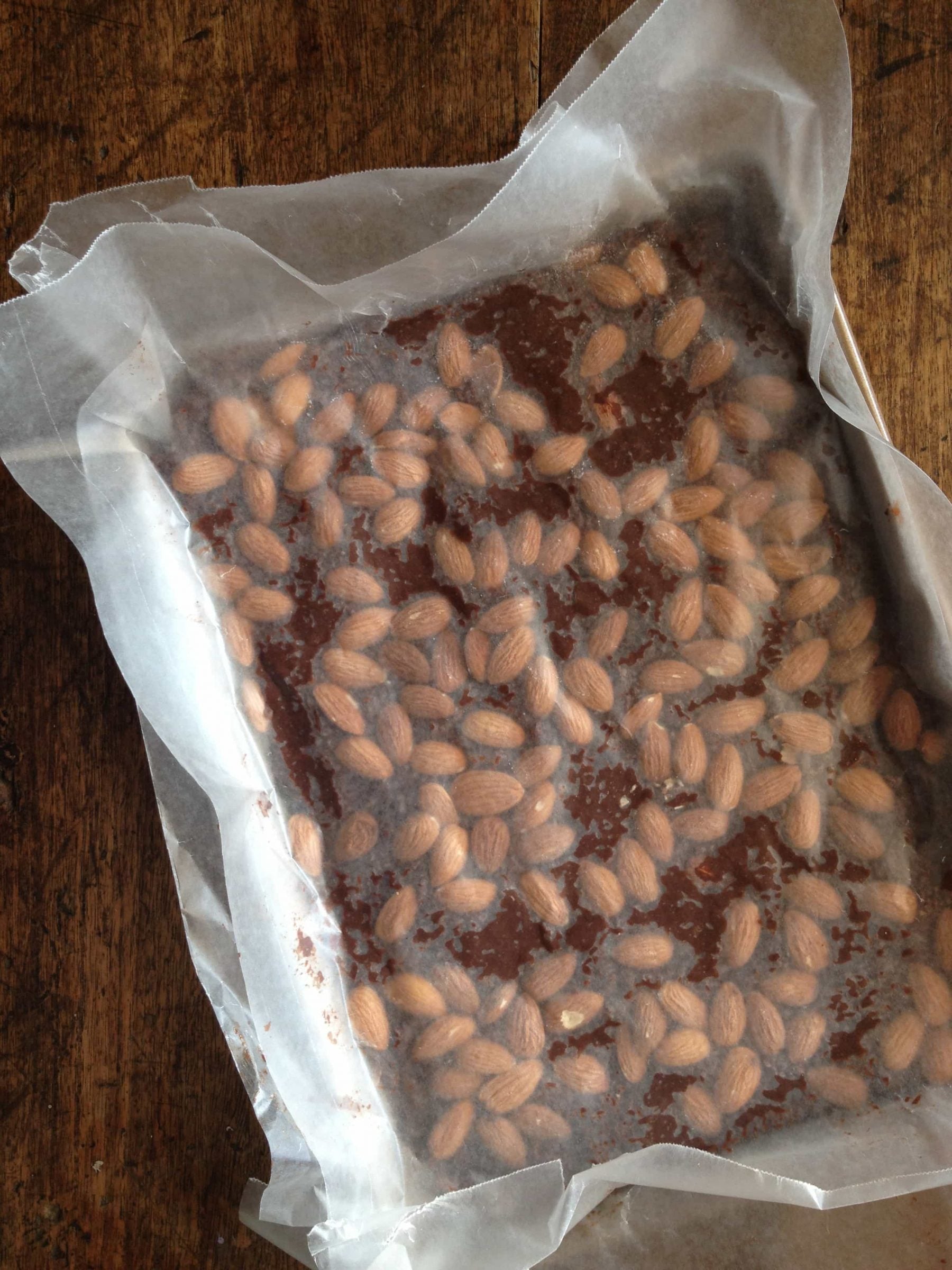 Chocolate almond bars covered in parchment paper.