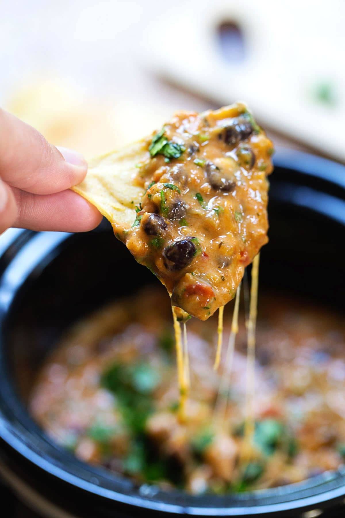 Cheesy Chili Dip on a tortilla chip.