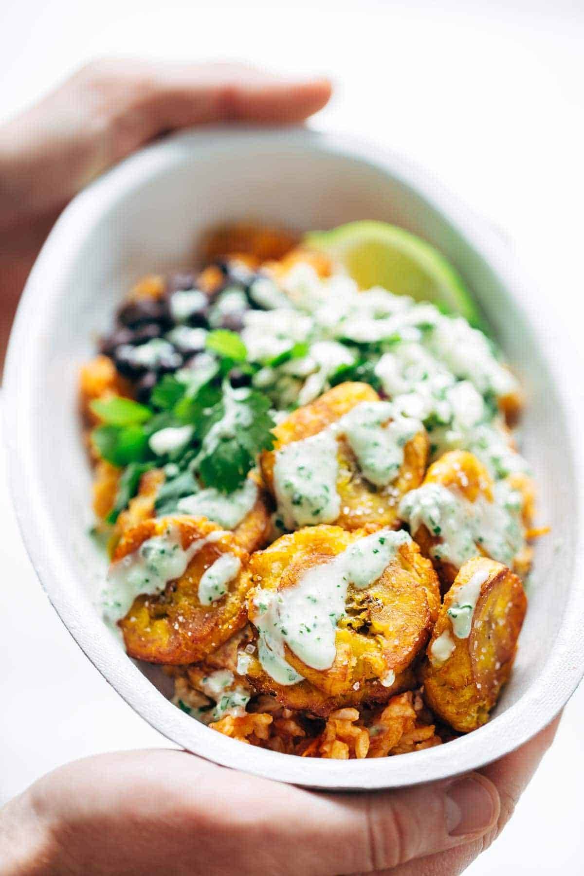 Spicy Brazilian Burrito Bowls recipe featuring seasoned rice and beans, garlic cilantro lime slaw, and crispy fried plantains. So good // almost vegan. | pinchofyum.com