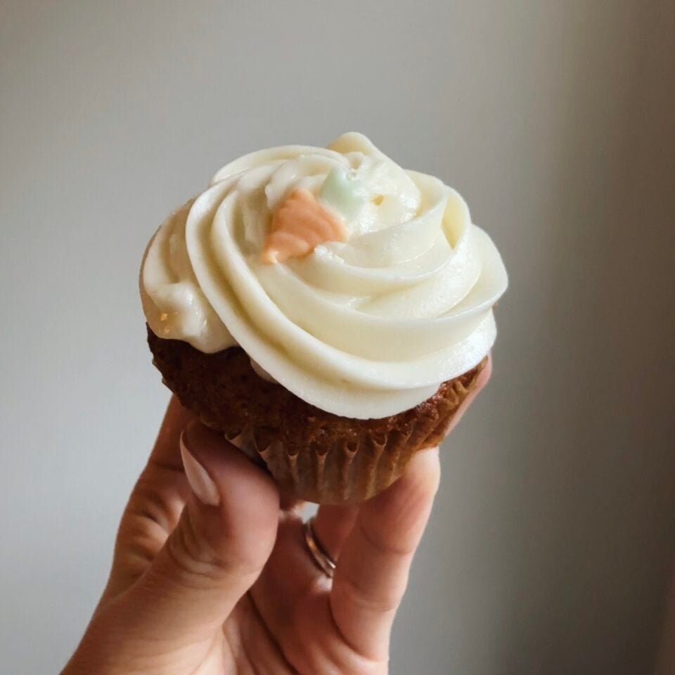 Carrot cake cupcake with carrot frosting decoration.