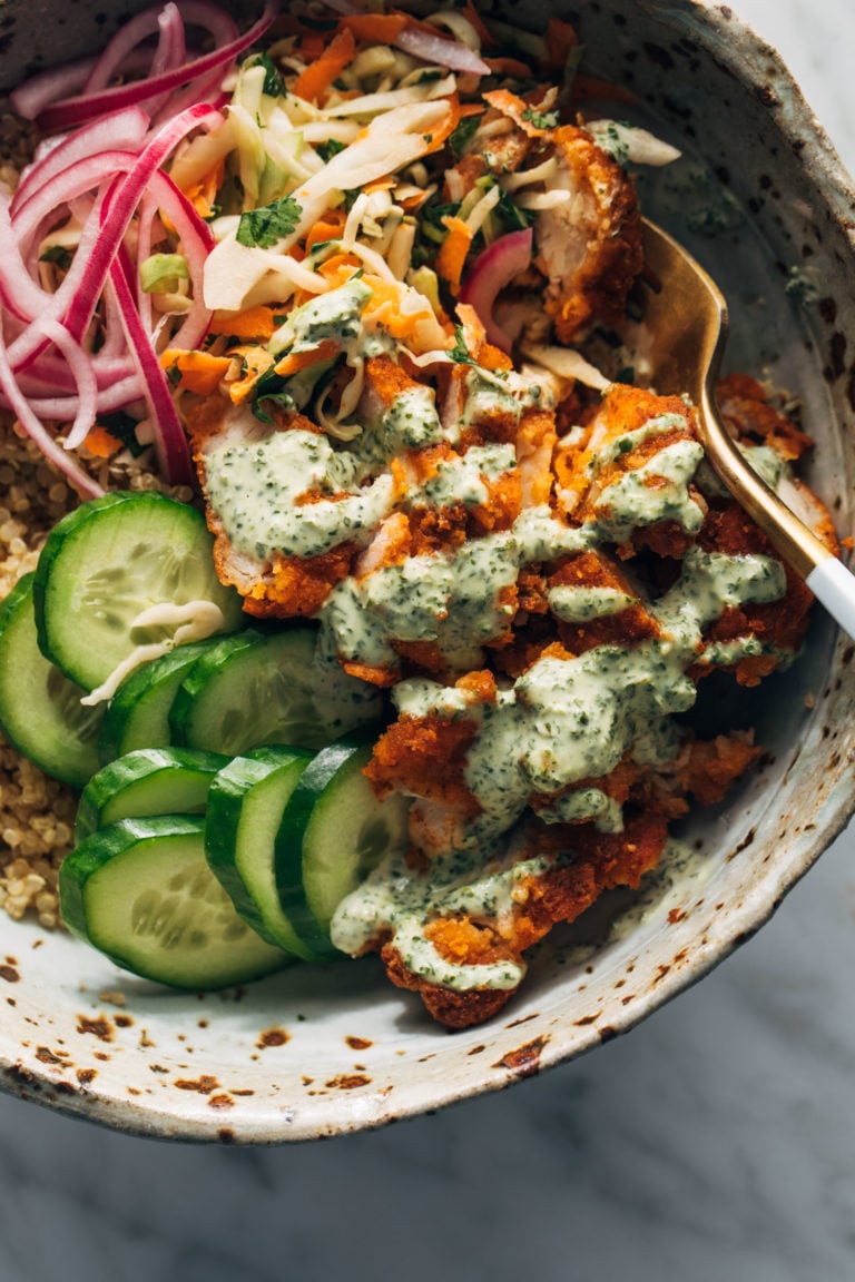Chicken tikka in bowls with quinoa and cucumber.
