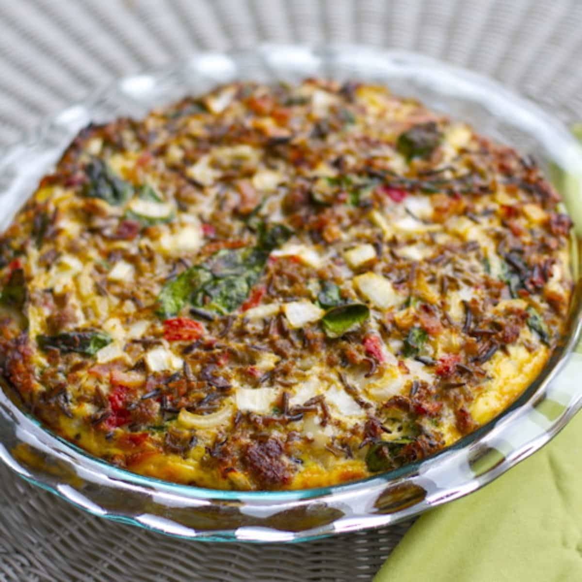 Sausage and red pepper quiche in a glass baking dish.