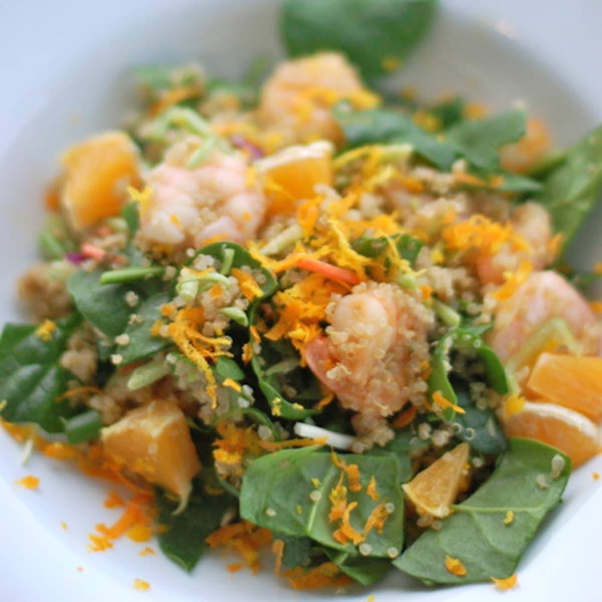 Shrimp and quinoa salad in a bowl with orange zest topping.