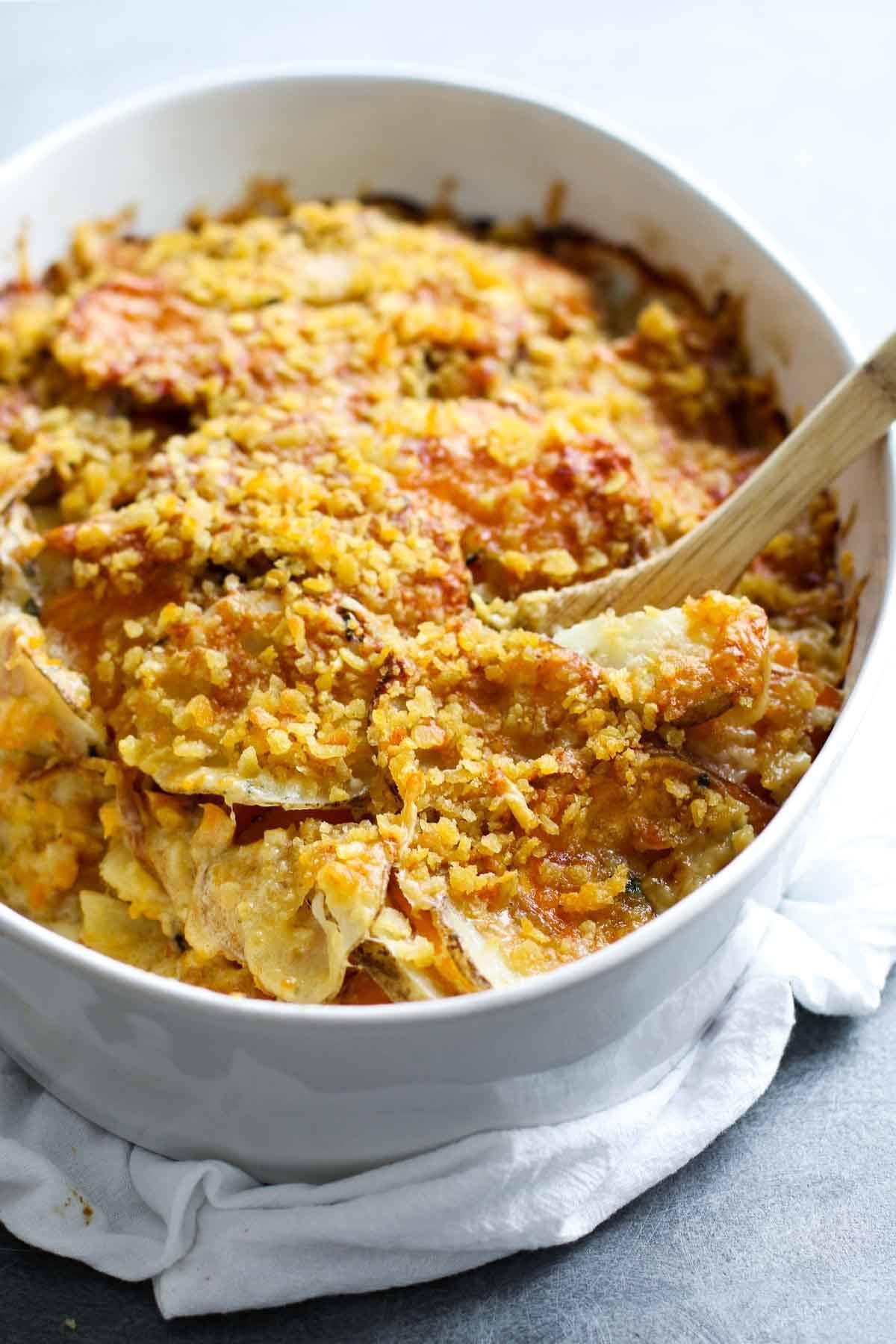 Garlic Herb Cheesy Potatoes in a white baking dish.