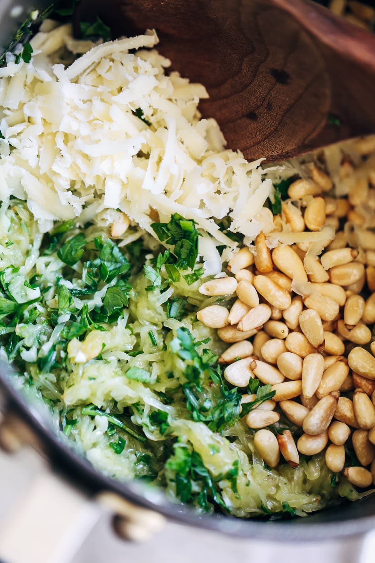 Herbs, cheese, and pine nuts.