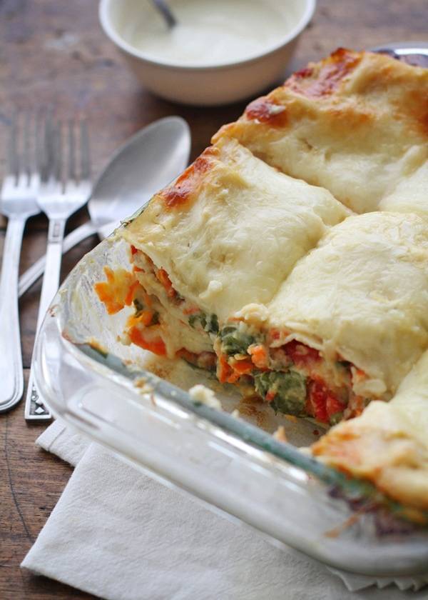 Veggie Alfredo lasagna in a clear baking dish.